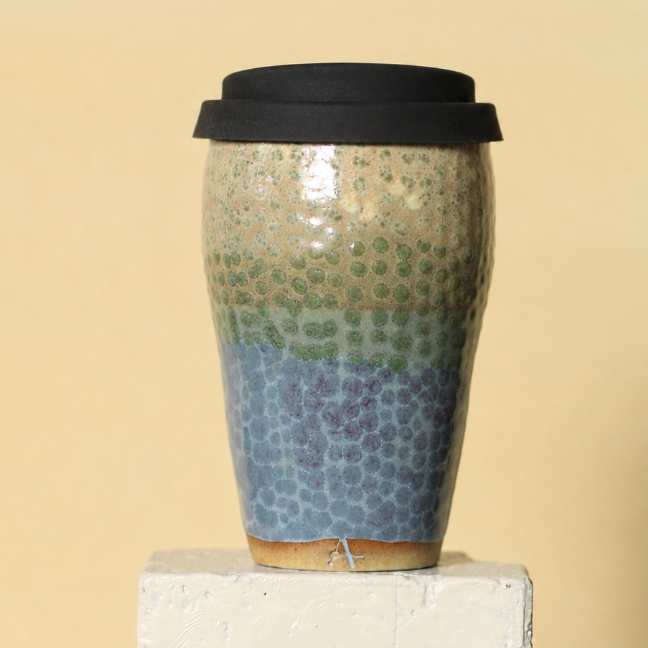 Ceramic mug with mosaic pattern on a beige background