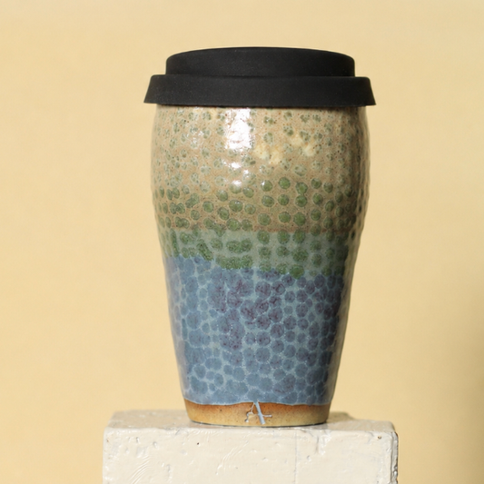 Ceramic mug with mosaic pattern on a beige background
