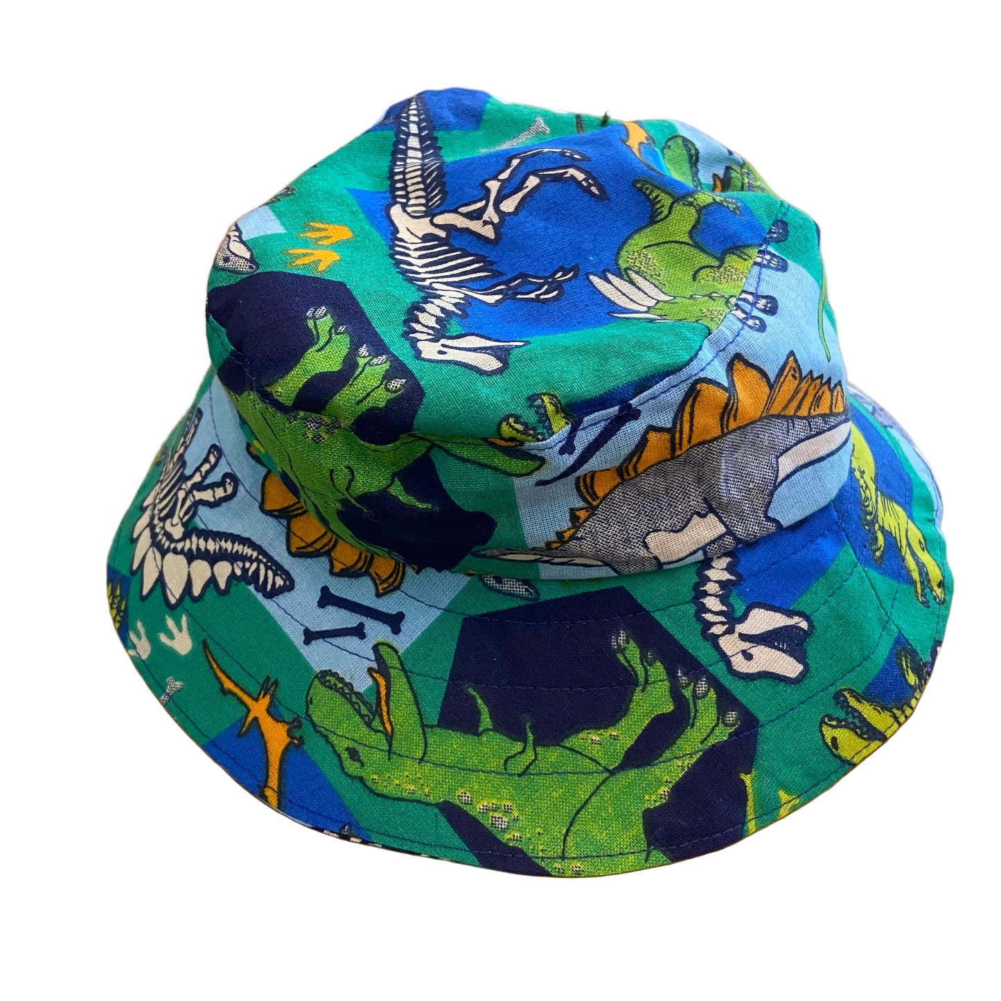Bucket hat with dinosaur pattern on a wooden surface