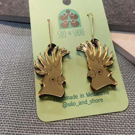 Gold cockatoo arcylic head earrings on a 'Silo & Shore' branded card.