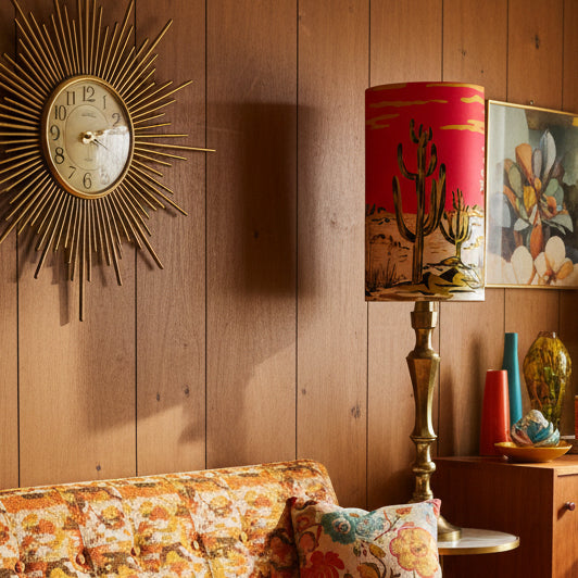 Lamp with a pink shade featuring cactus designs on a white background