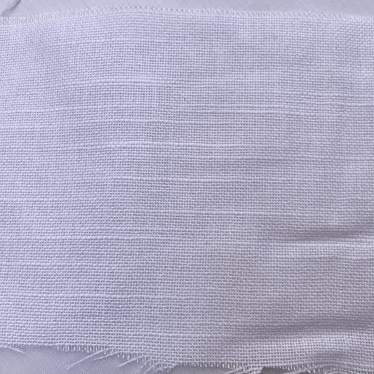 A close-up of a white woven fabric with a textured, frayed edge.