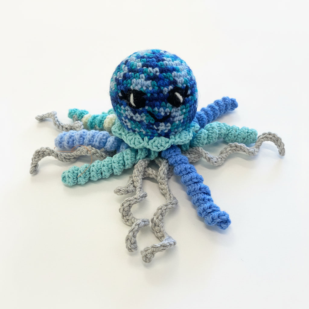 Crocheted octopus toy on a wooden surface