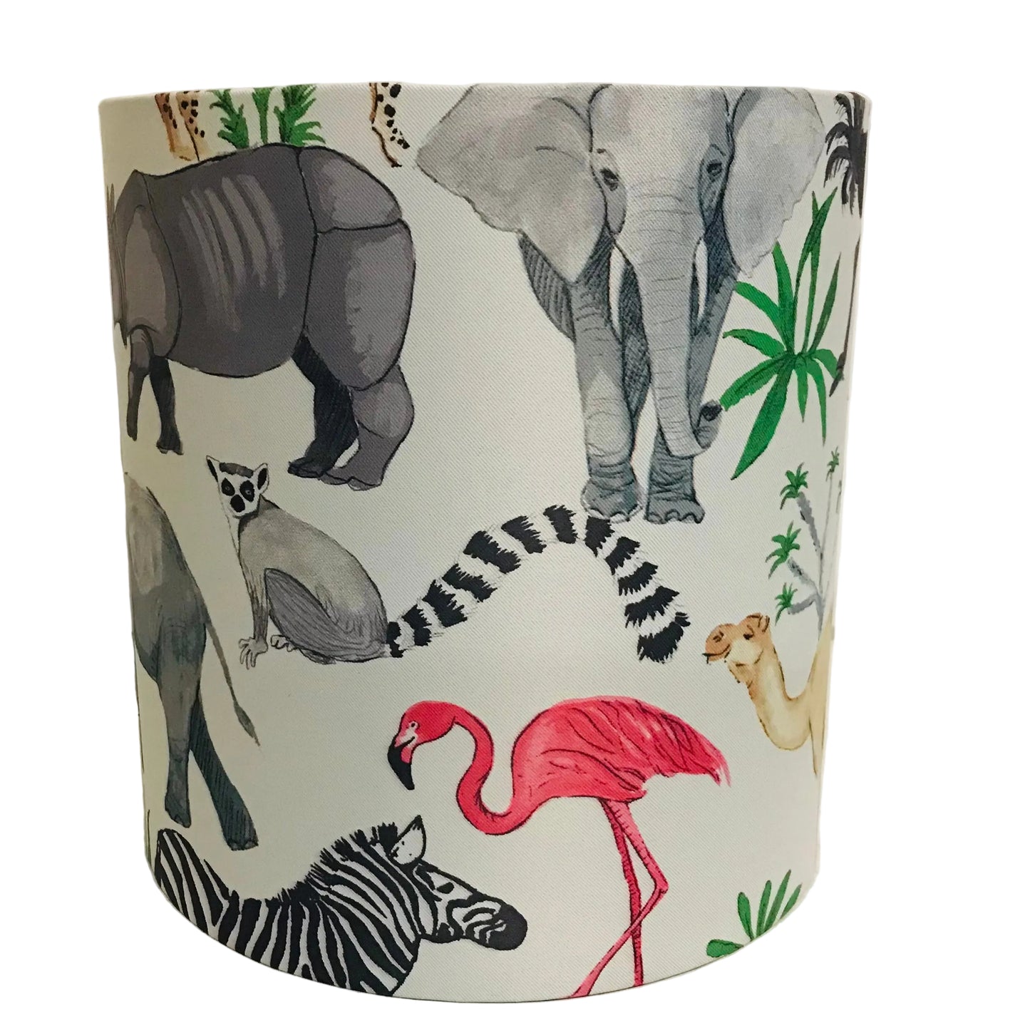 A cylindrical lampshade featuring a safari-themed animal print with a white background and illustrations of a pink flamingo, zebra, elephant, rhino, lemur, camel, and green palm leaves.