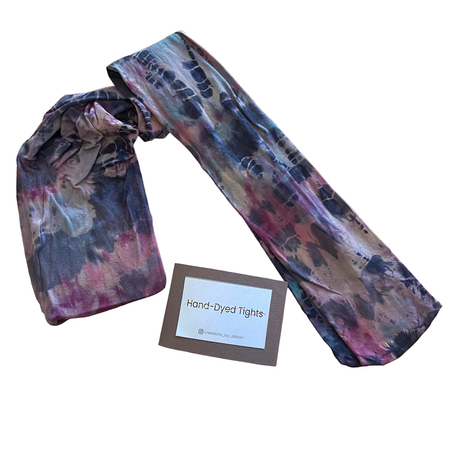 Hand-dyed tights with a label on a wooden surface