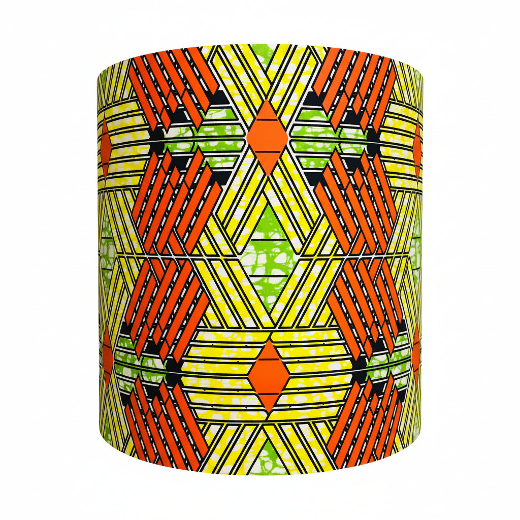 Geometric patterned lampshade on a stand against a neutral wall.