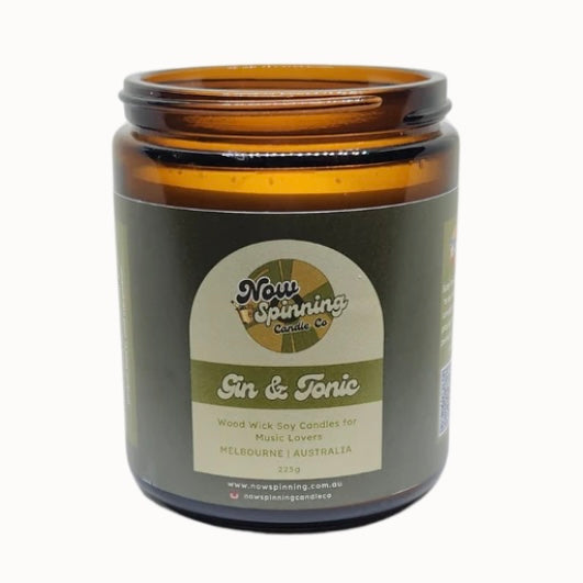 Amber glass candle jar with a label on a white background