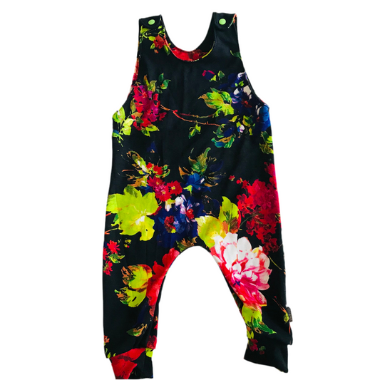 Colorful floral-patterned handmade baby romper overalls on a white background