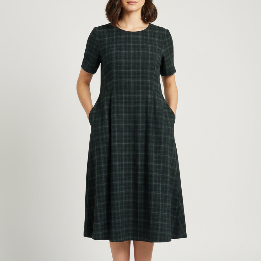 A short-sleeve dark green plaid dress on a model