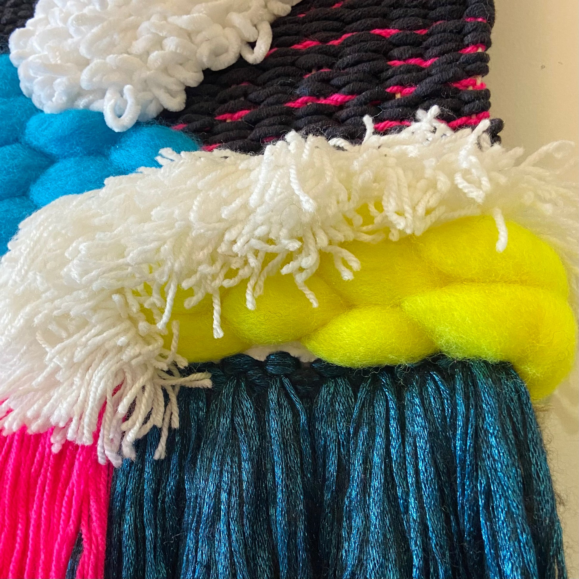 Close-up of colorful yarn with various textures and colors.