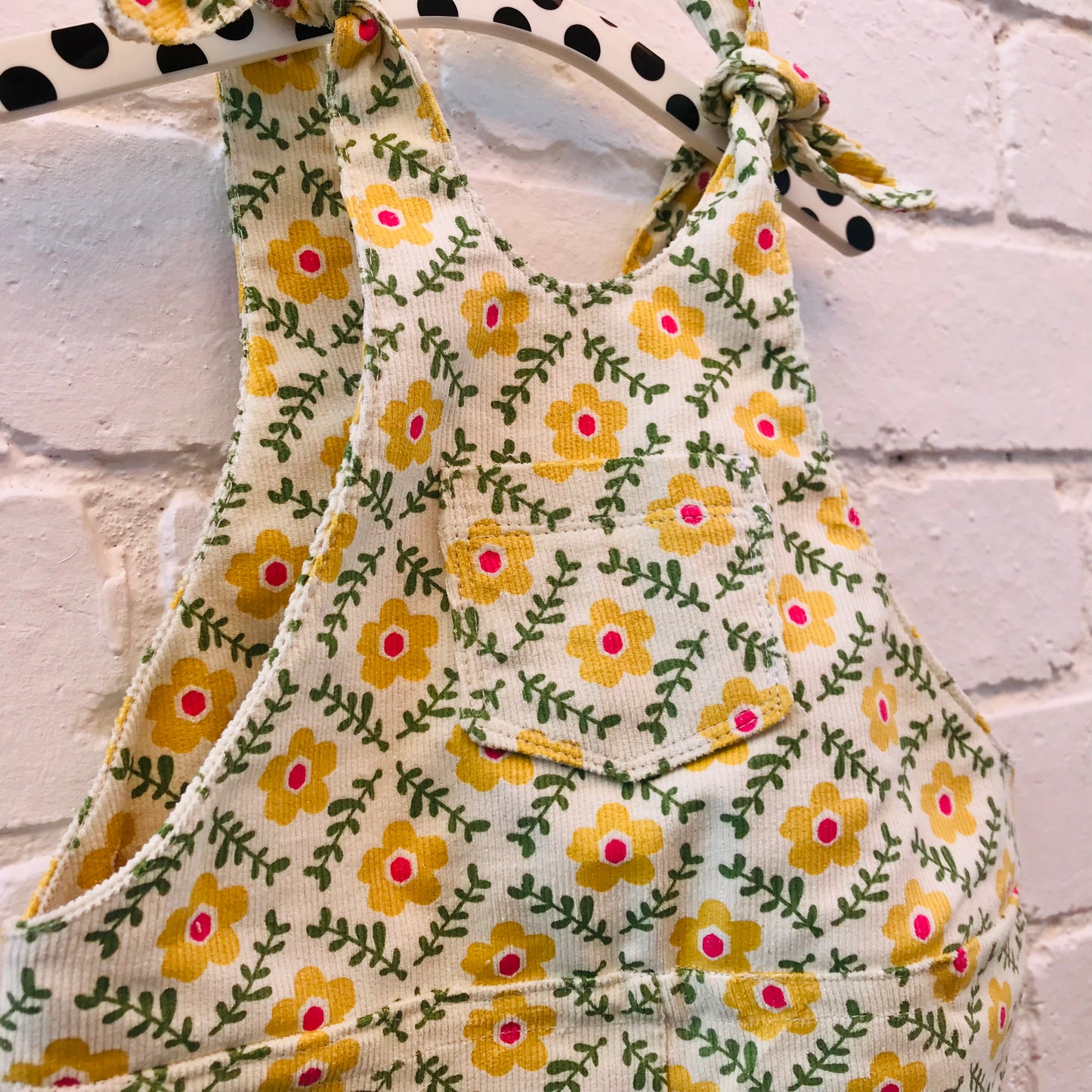 kids overalls with tie shoulders and yellow flower print, made of pinwale cord