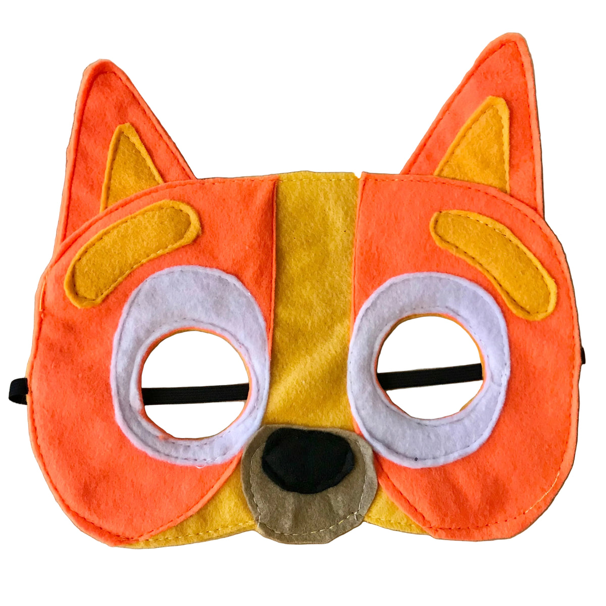 A handmade felt animal face mask shaped like a fox or dog, featuring orange and yellow panels, white eye cutouts with black elastic bands, and a black nose on a light wood background.