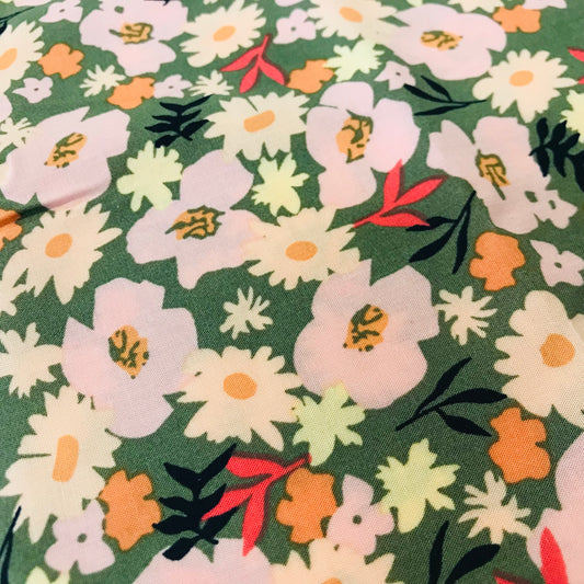 Floral pattern with colorful flowers on a green background