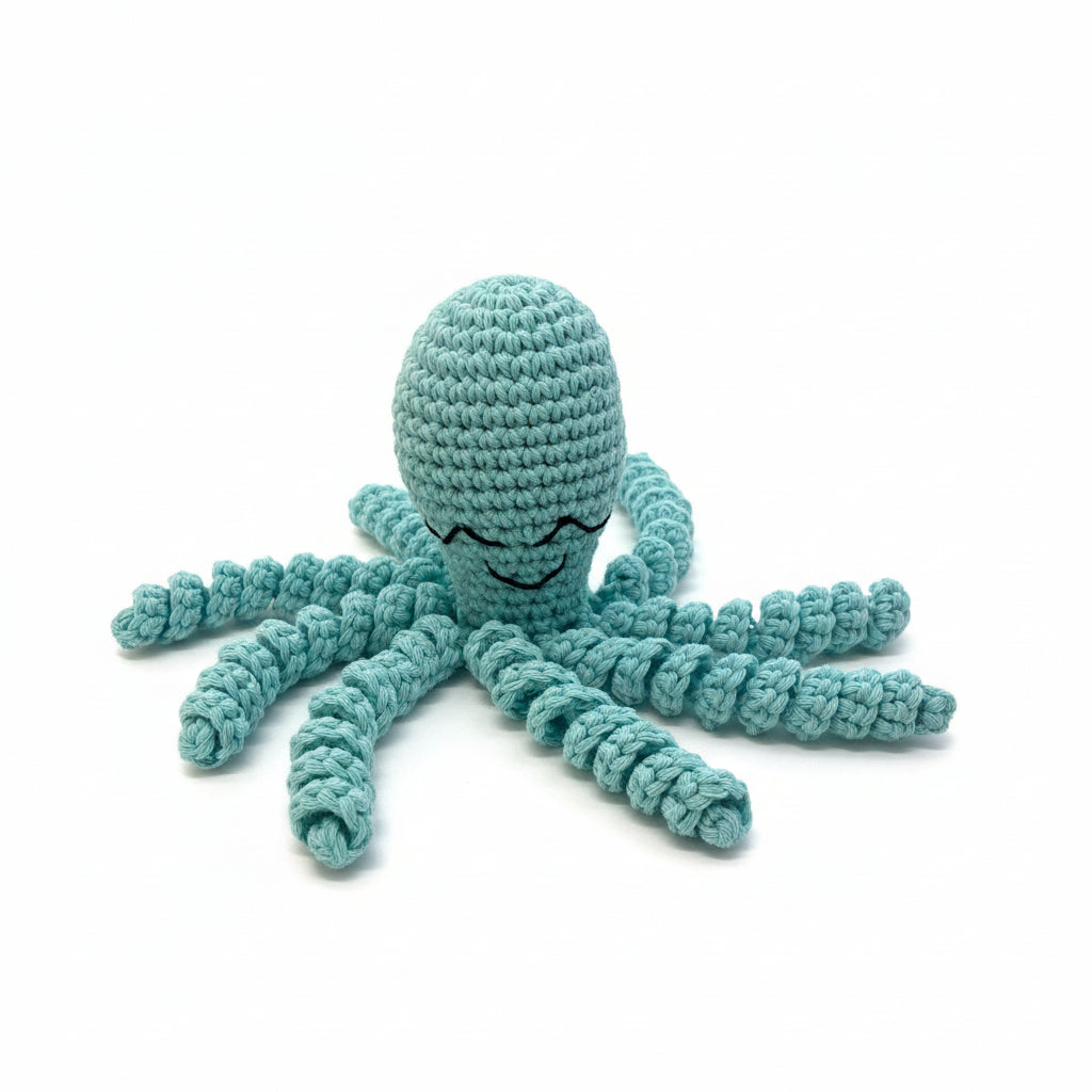 Crocheted blue octopus toy on a wooden surface
