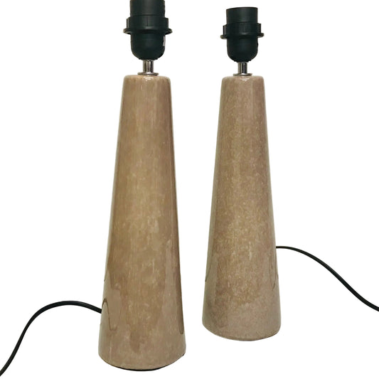 Two cone-shaped lamps with beige bodies and black bases on a white surface.