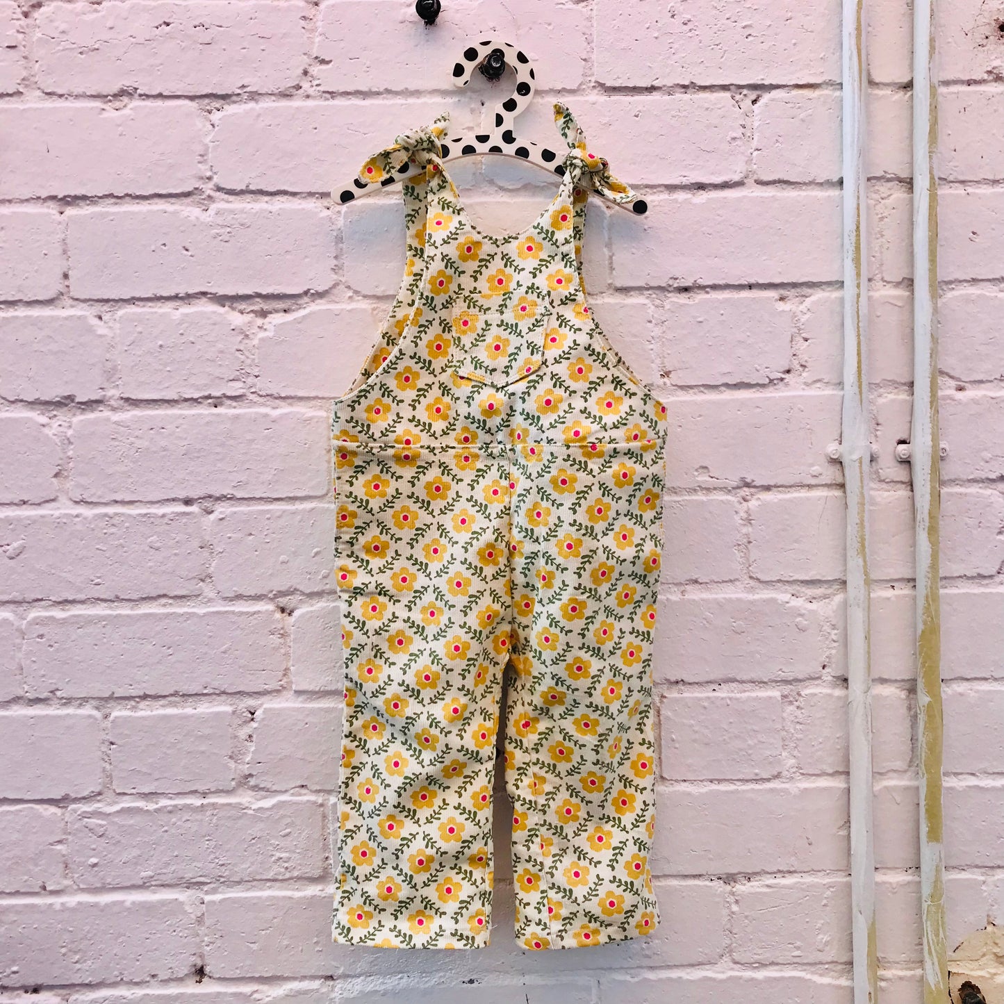 kids overalls with tie shoulders and yellow flower print, made of pinwale cord
