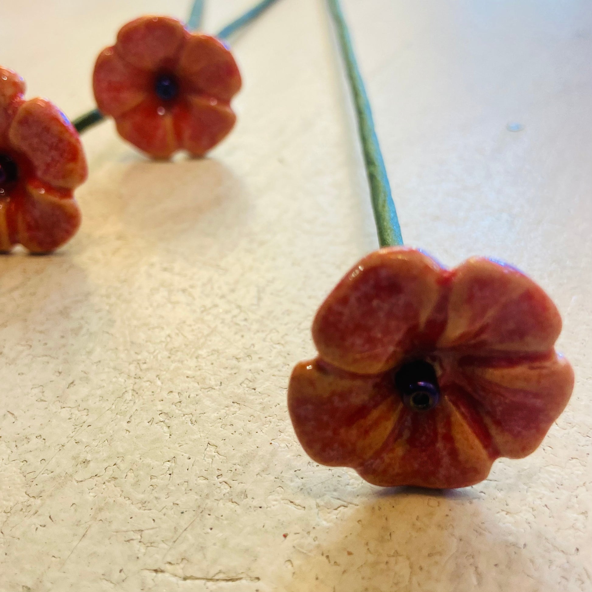 Close-up of decorative flower beads on a textured surface