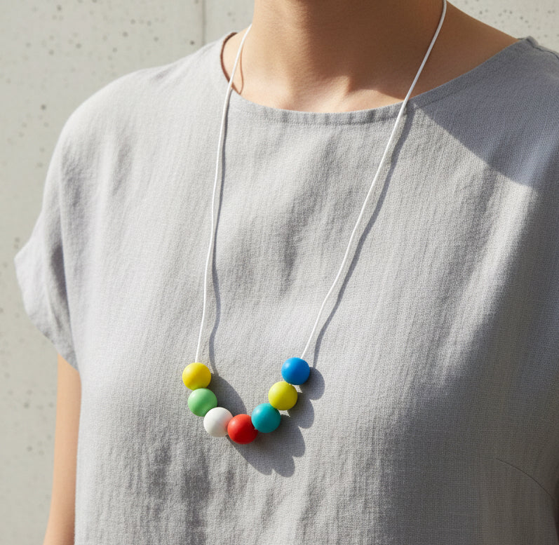 Colorful bead necklace on a textured surface
