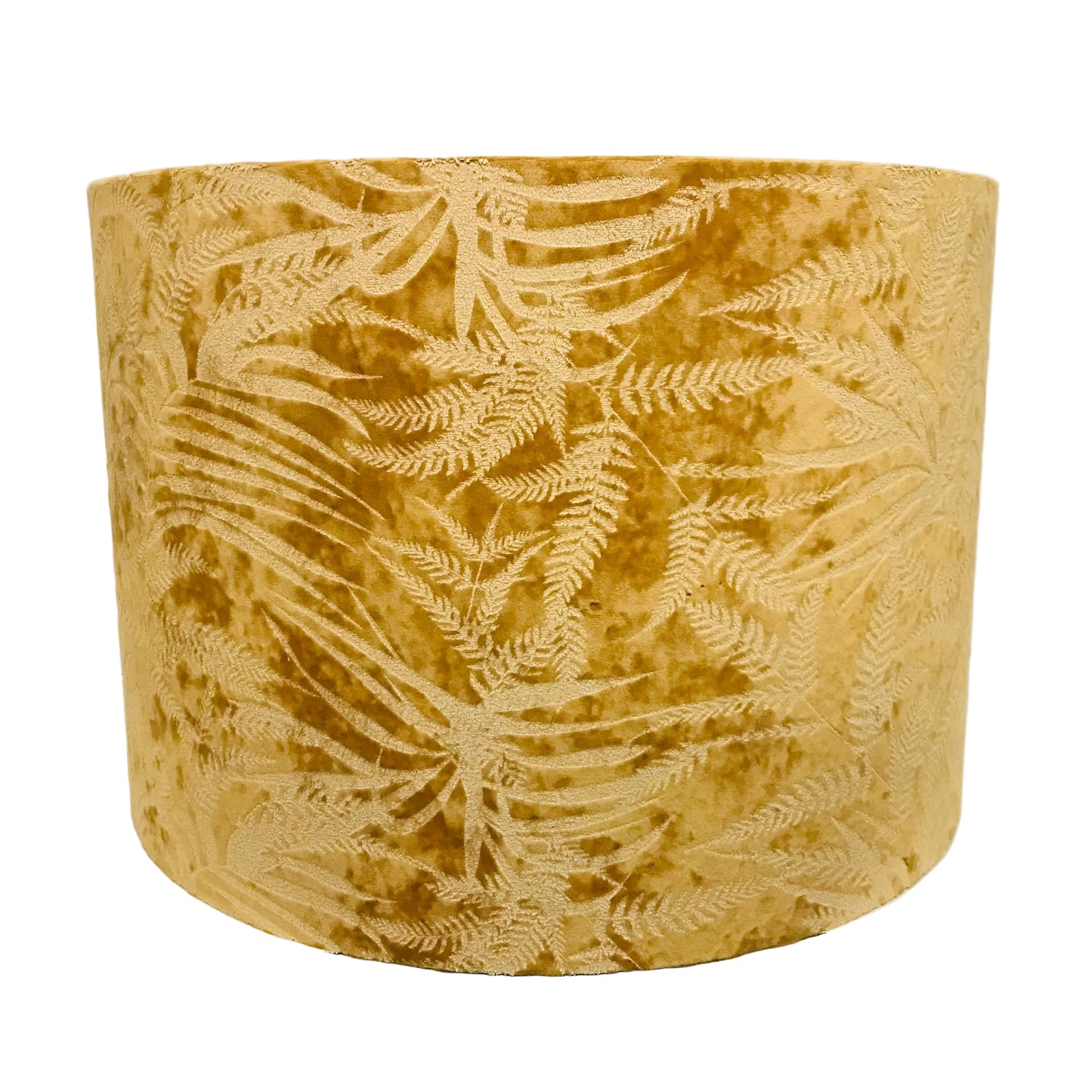 A cylindrical drum lampshade made of textured mustard yellow velvet with an embossed or woven fern leaf pattern