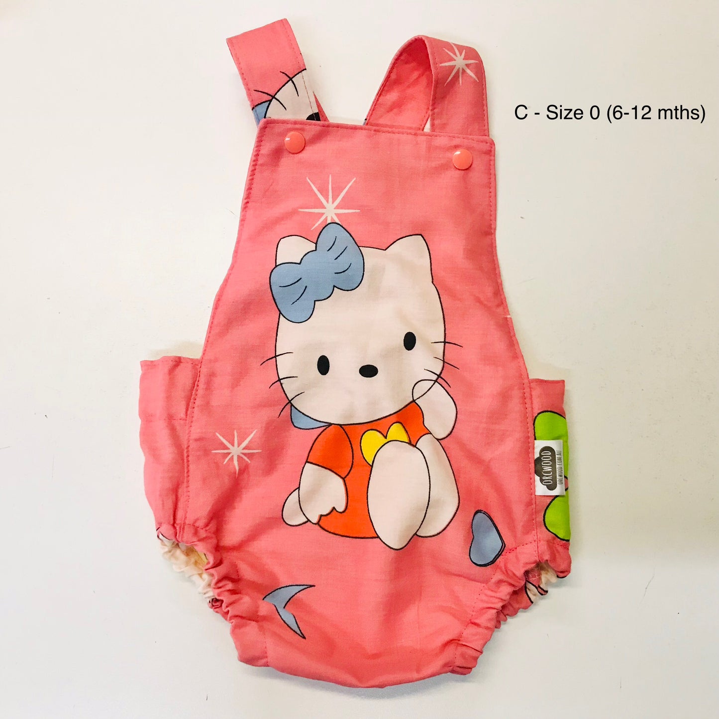 Pink children's romper with cartoon character on a white background