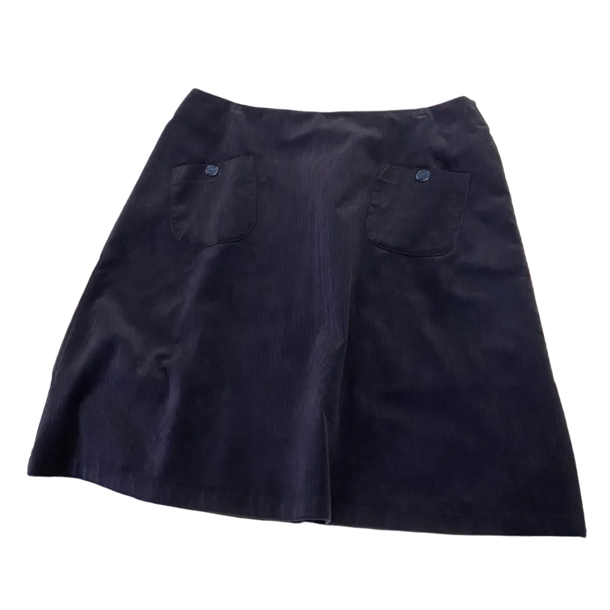 Navy blue cord skirt on a white table with various items around