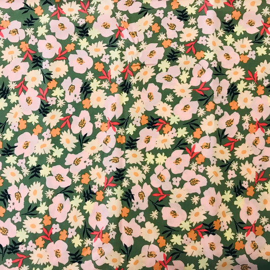 Floral pattern with white and pink flowers on a green background