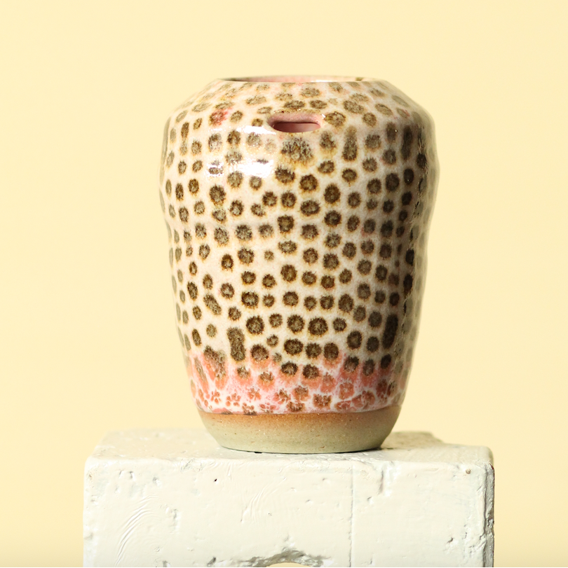 Decorative vase with a floral pattern on a beige background