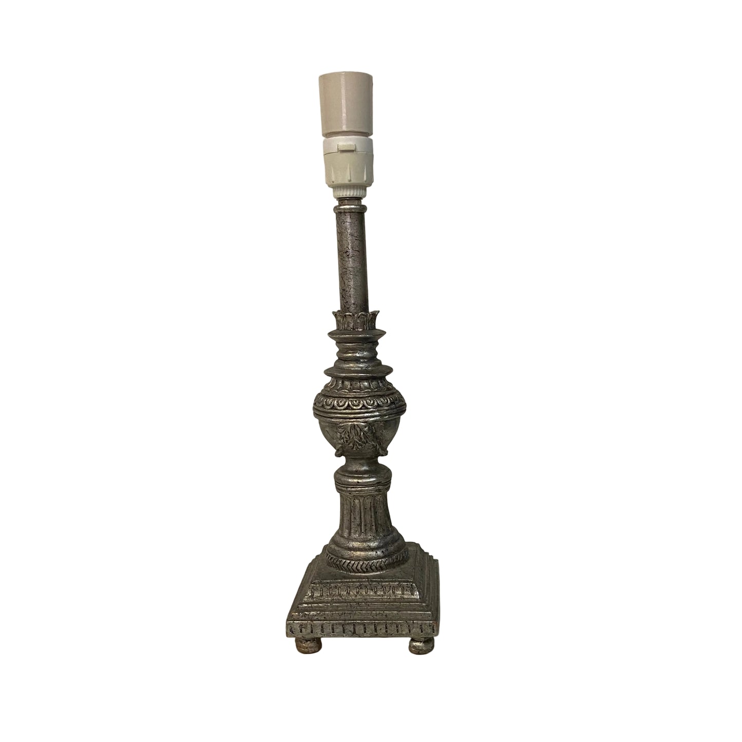 Decorative candlestick lamp on a white surface with a plain background