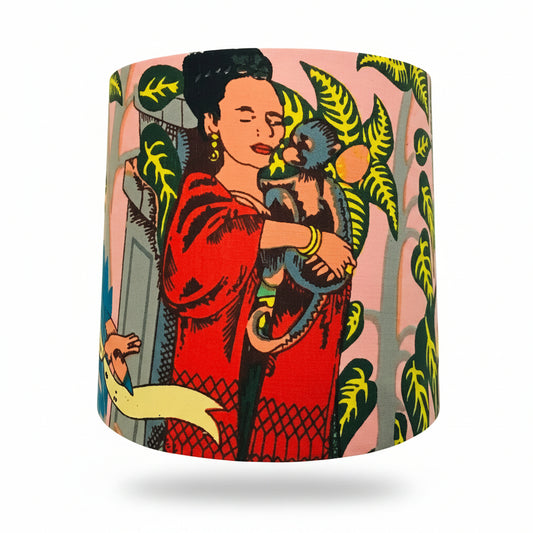Lampshade with a colorful design of a woman holding a monkey against a pink background