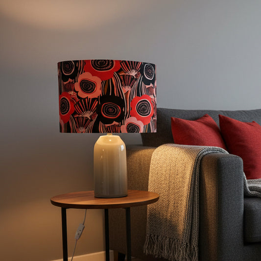 Lamp with a colorful floral patterned shade on a white background