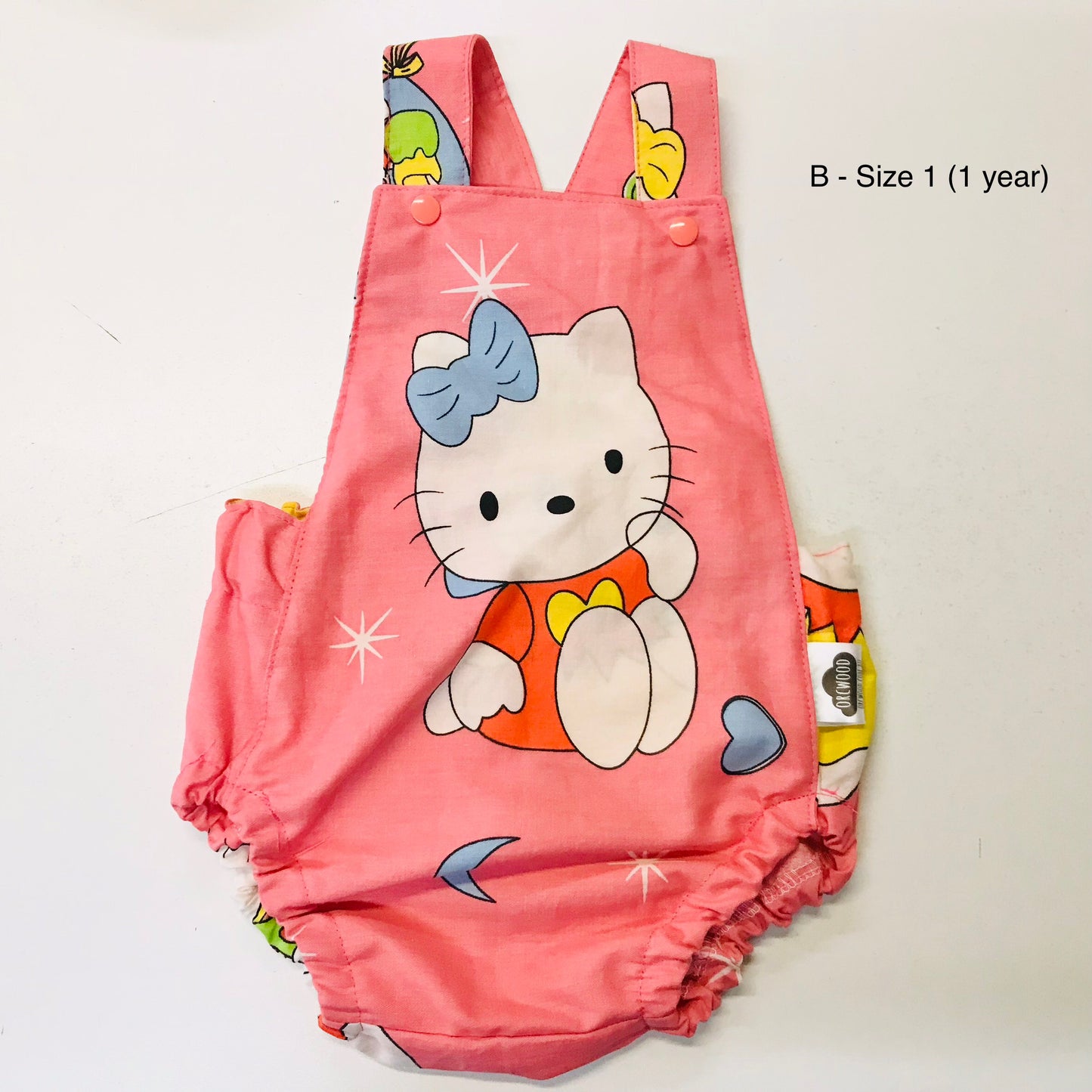 Pink children's romper with cartoon character on a white background