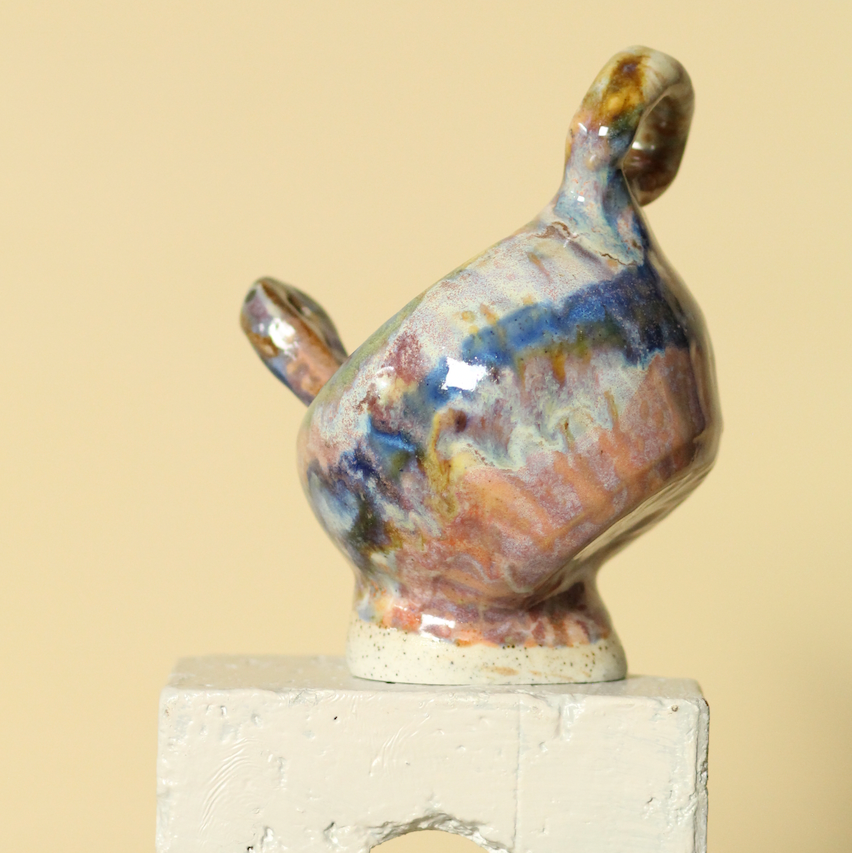 Ceramic sculpture of a duck on a beige background