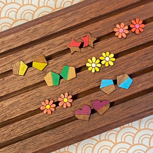 Colorful wooden earrings on a wooden surface