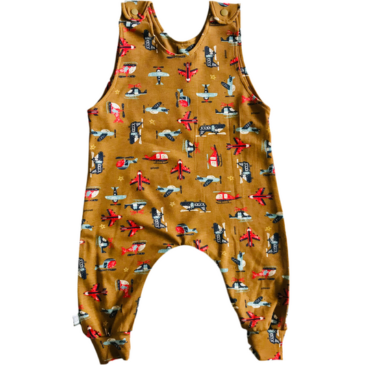 Children's sleeveless romper with airplane pattern on a mustard background