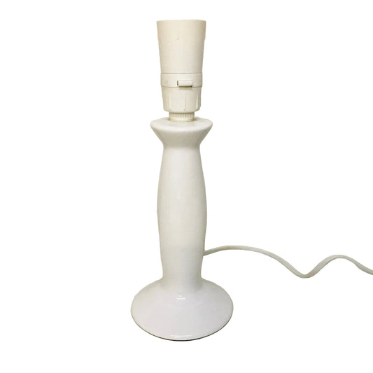 White table lamp on a white surface with a plain background