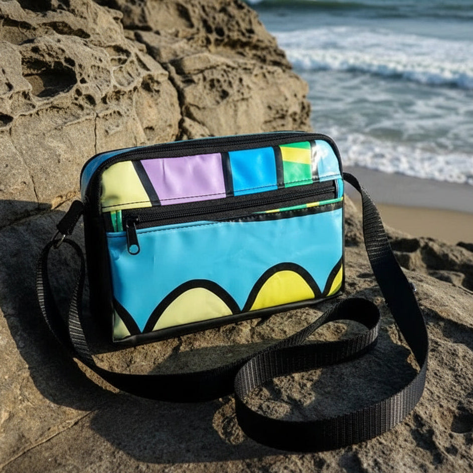 Colorful bag with geometric pattern on a rocky beach