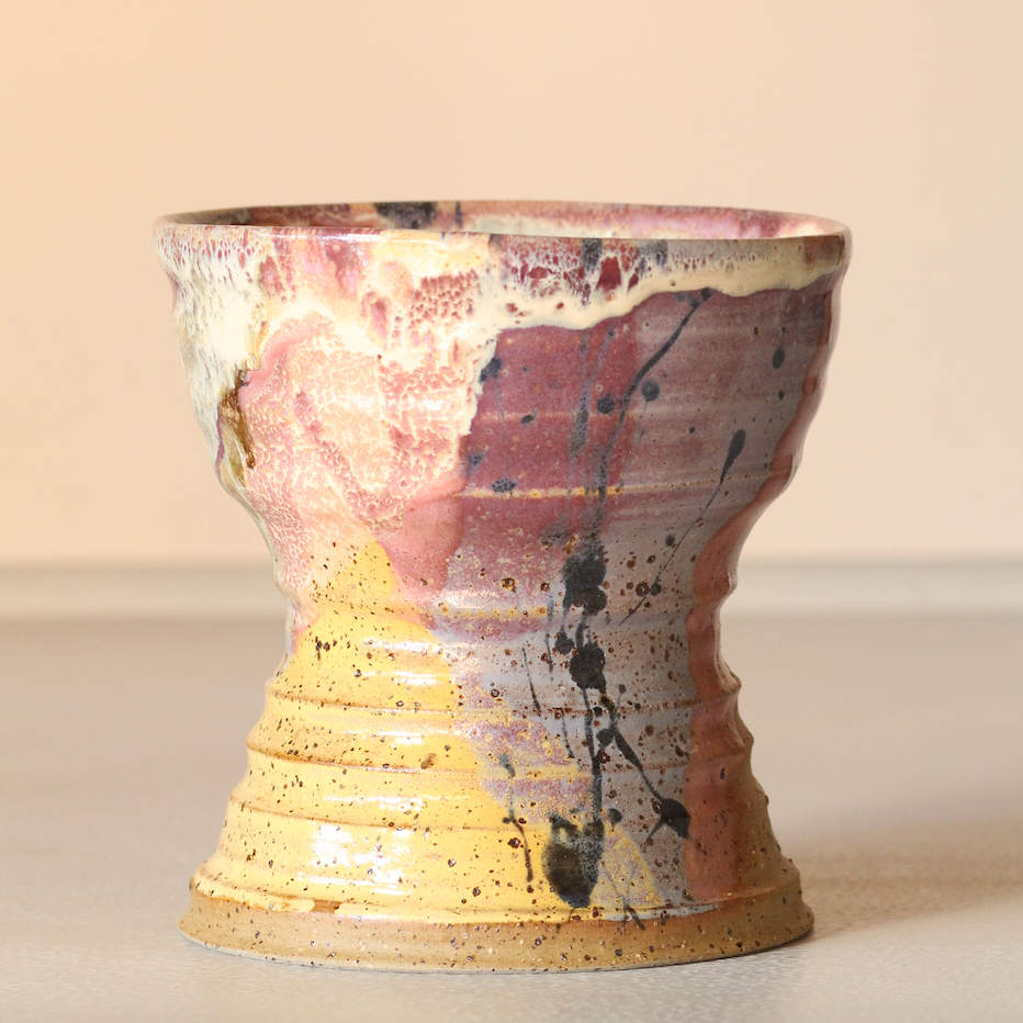 Ceramic vase with abstract design on a beige background