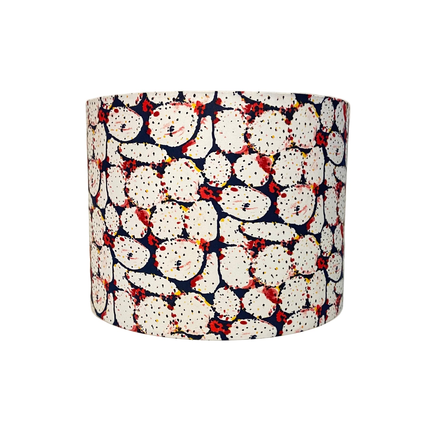 Cylindrical lampshade with a pattern of white shapes on a blue background