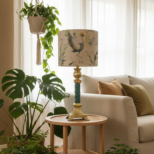 Decorative lamp with a bird-themed shade on a white surface.