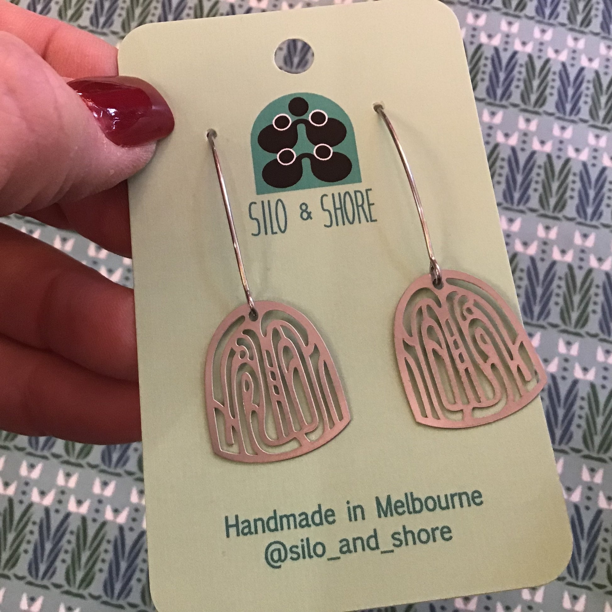 Silo & Shore earrings on a branded card with a patterned background