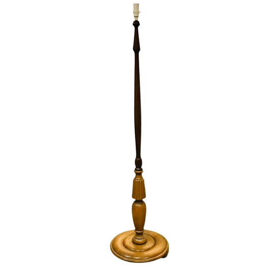 Wooden floor lamp with a long dark pole on a white background