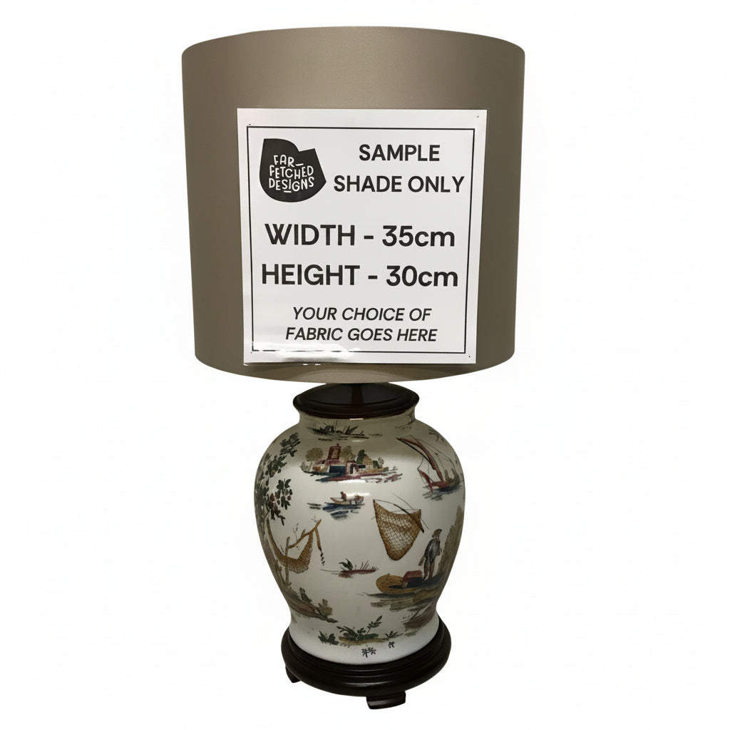 Decorative lamp with a sample shade and ceramic base on a plain background