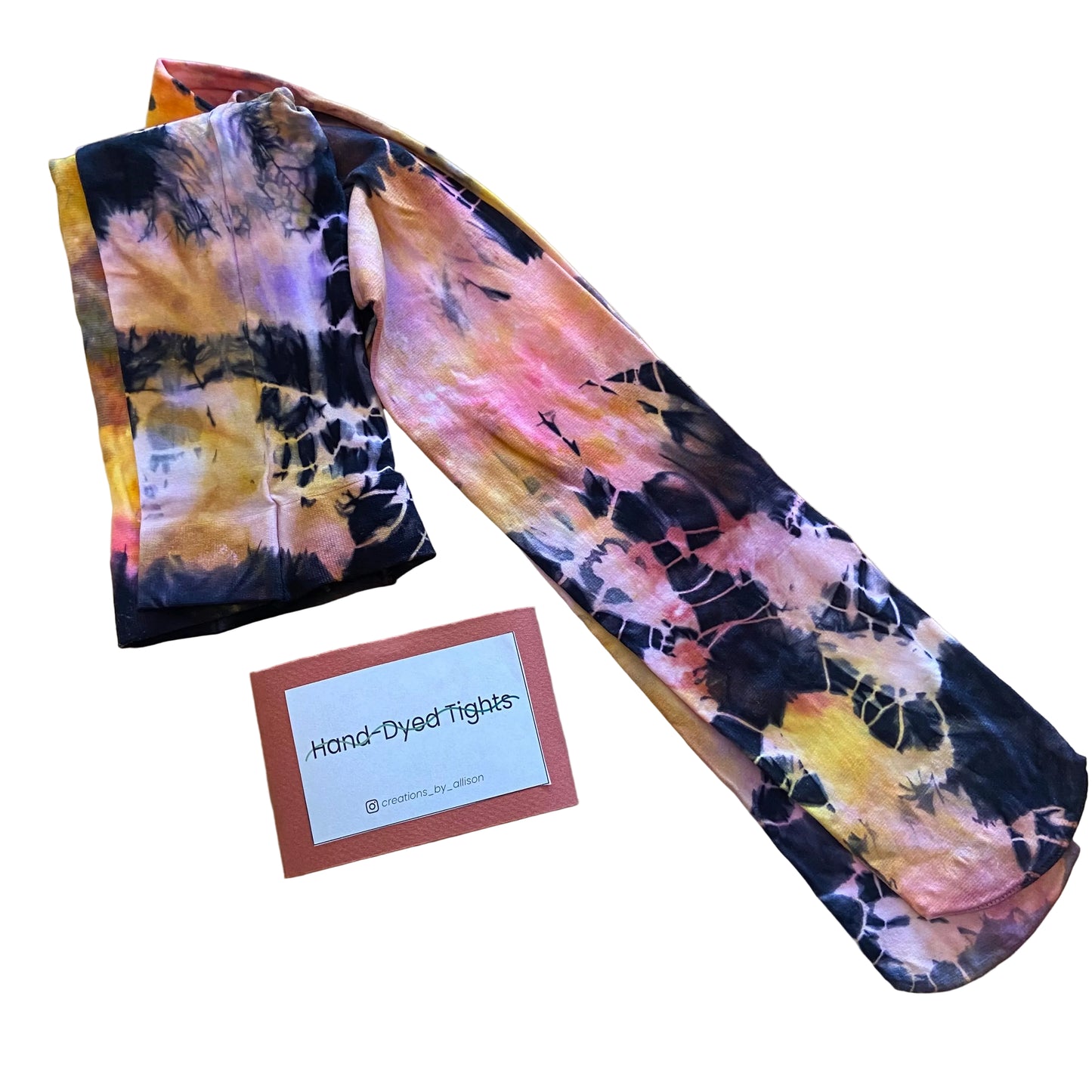 Hand-dyed tights with a card labeled 'Hand-Dyed Tights' on a wooden surface