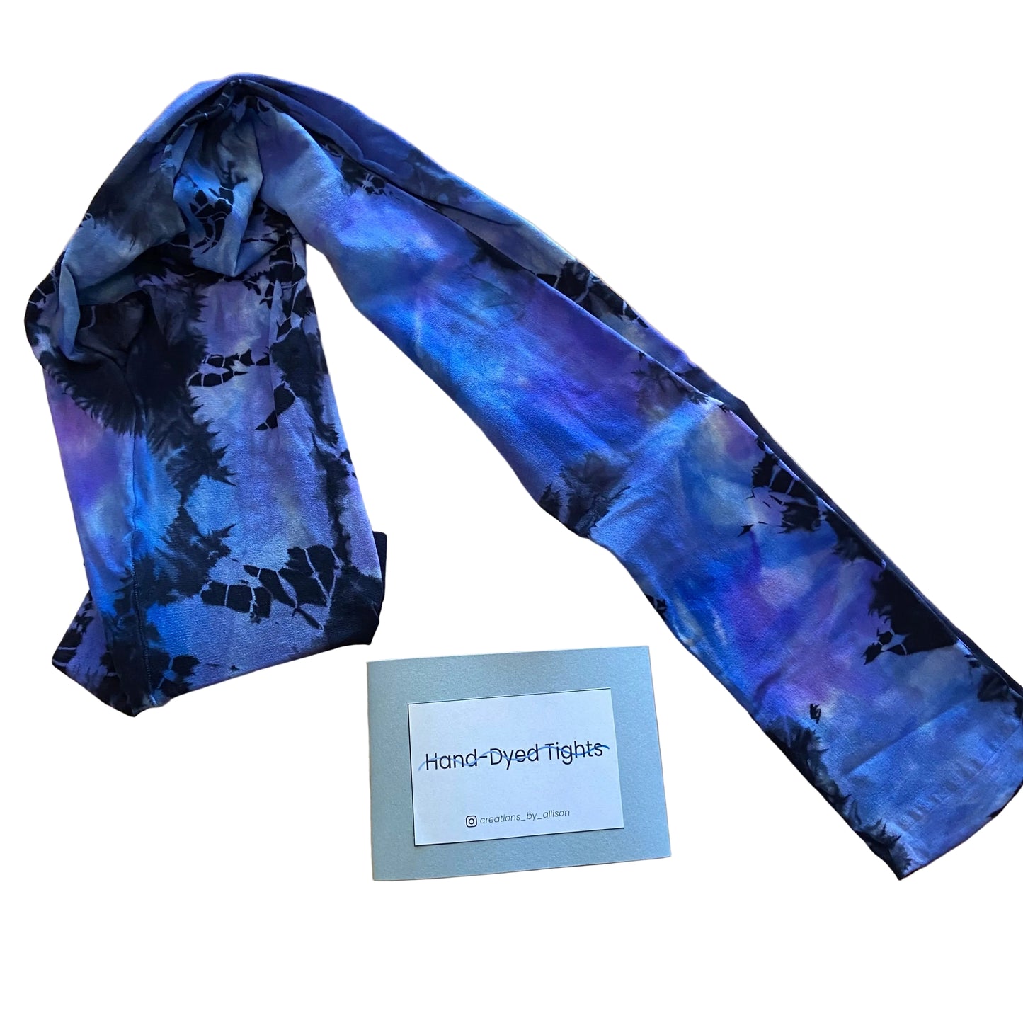 Hand-dyed tights with a label on a wooden surface
