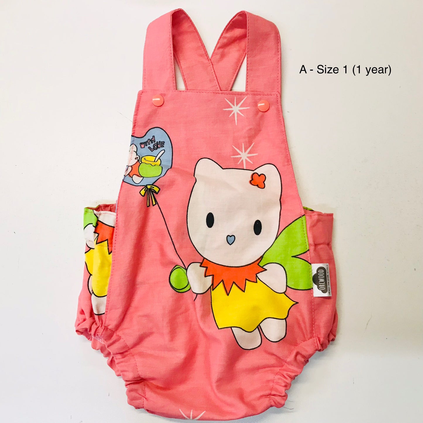 Pink children's romper with cartoon design on a white background