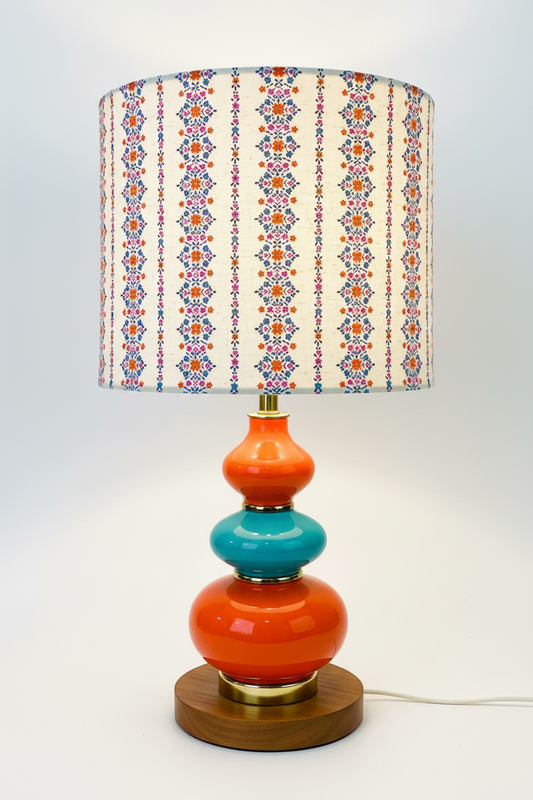 Colorful lamp with a patterned shade on a white background