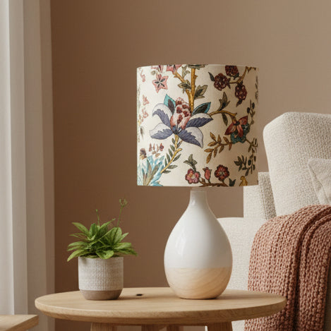 Lamp with floral patterned shade on a white surface