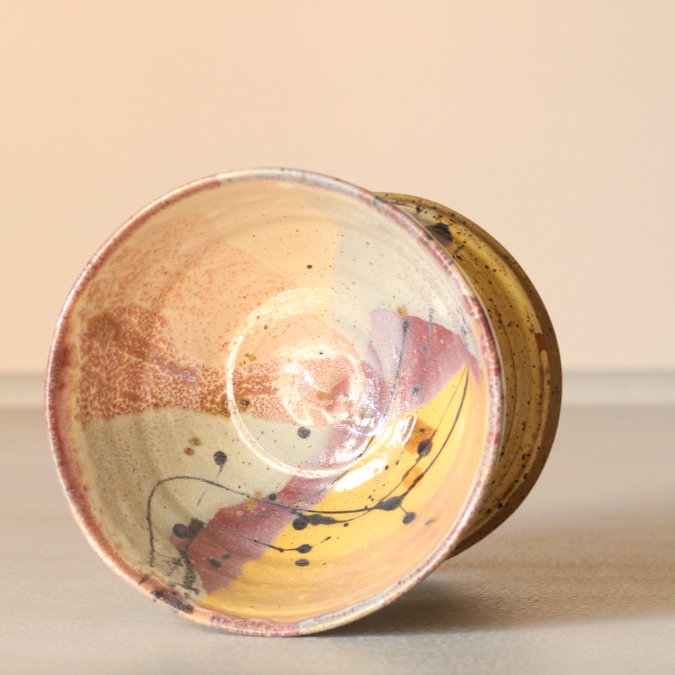 Ceramic bowl with artistic design on a beige background