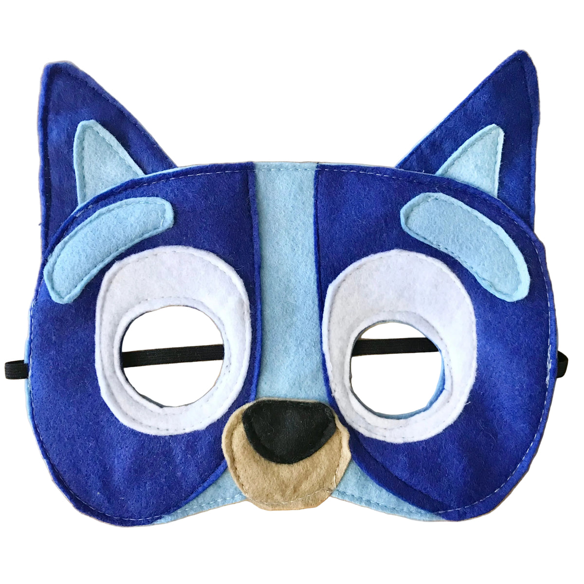 A blue and light blue felt animal face mask with white eye patches, a beige snout, and black elastic straps, laid flat on a light wood background.