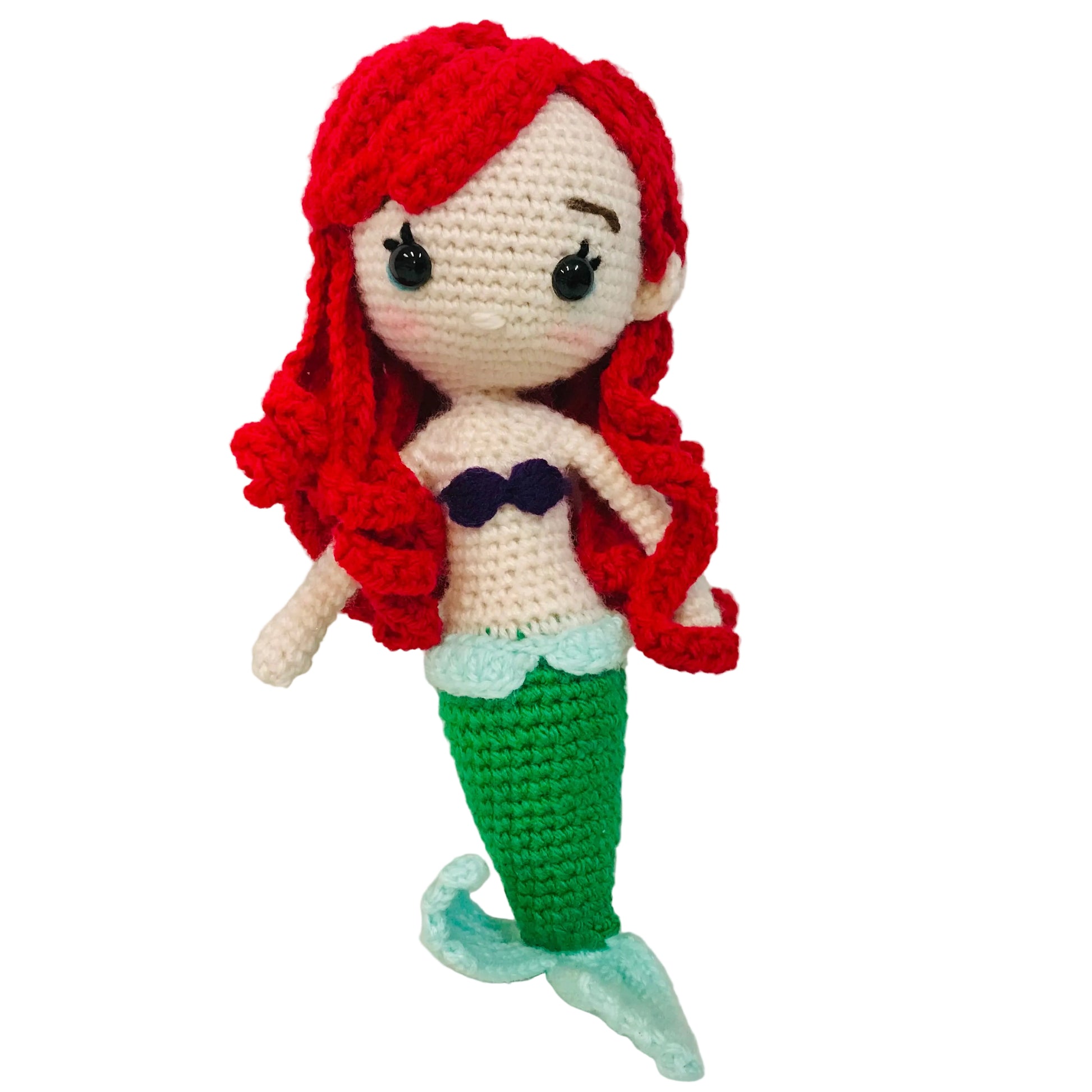 Crocheted mermaid doll with red hair and green tail on a white background